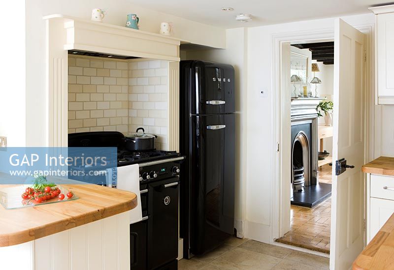 Black fridge freezer and large range cooker in modern country kitchen 