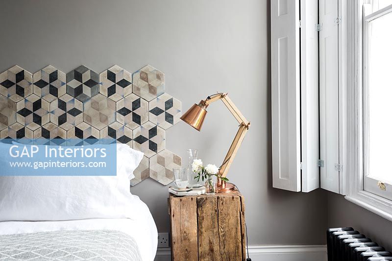 Modern bedroom with patterned headboard 
