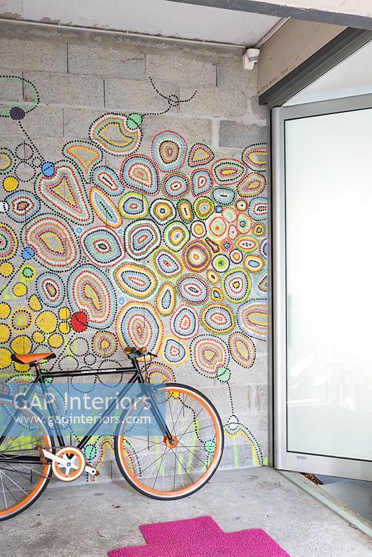 Colourful mural on hallway wall with bicycle 