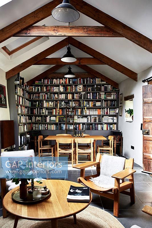 Open plan living and dining area with bookcase wall 