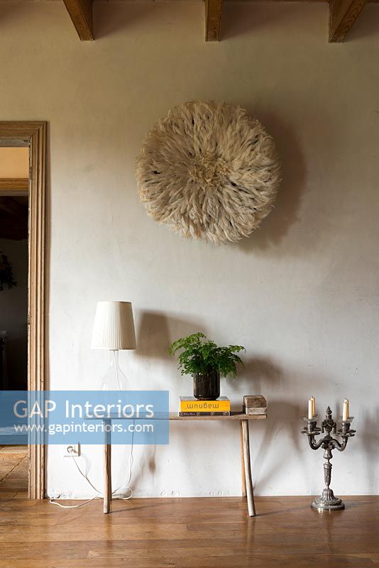 Textured circular wall hanging and small side table 
