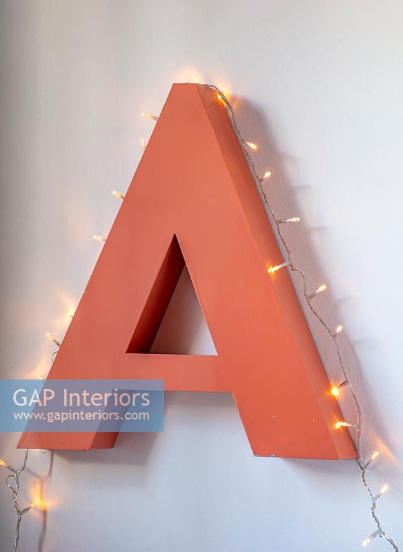 Large orange letter A with fairlights 