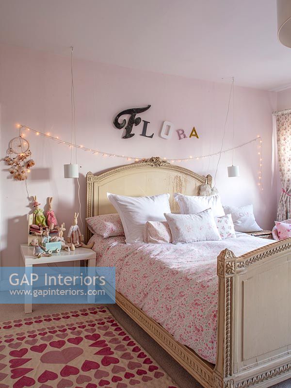 Childrens room with name in lettering and fairy lights over bed 