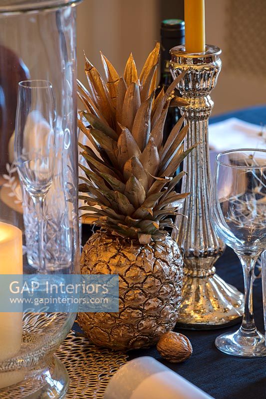 Gold painted pineapple as dining table decoration 