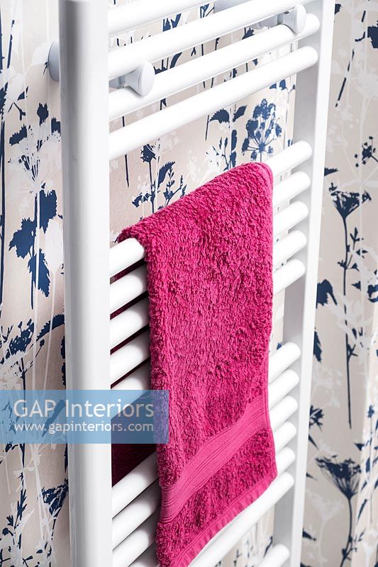Pink towel on white towel radiator 