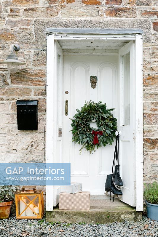 Cornish cottage doorway decorated for Christmas 