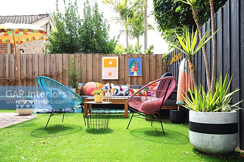Colourful outdoor living area with artificial grass 