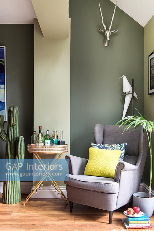 Green painted walls in modern living room 