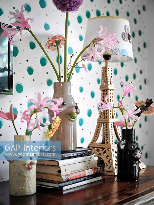 Flowers in vases and Eiffel Tower shaped lamp