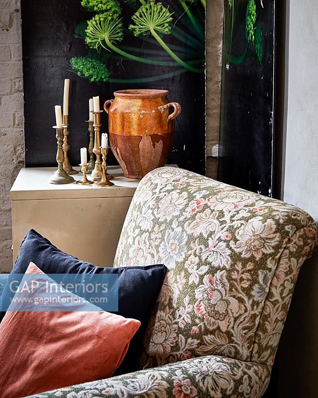 Floral armchair in corner of country living room 