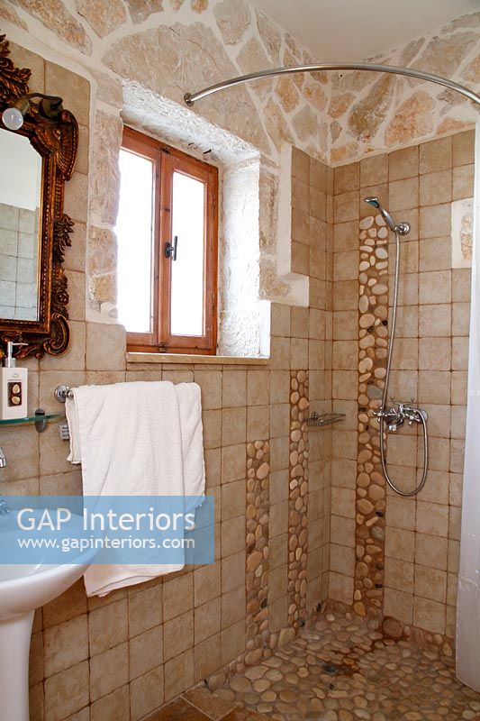 Exposed stone wall in country bathroom 