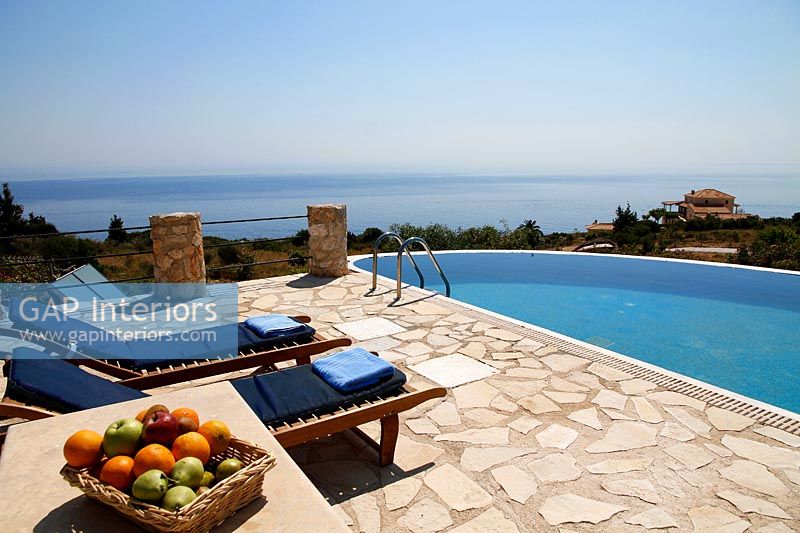 Swimming pool and recliners with sea views 