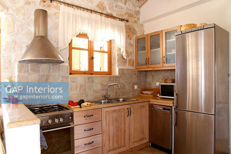 Country kitchen with exposed stone wall