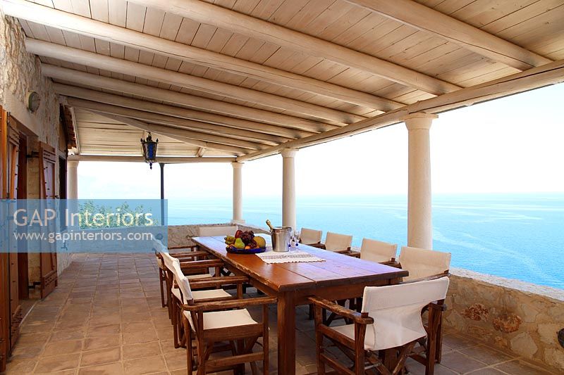 Large dining area on covered terrace with sea views 