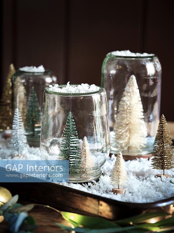 Homemade snow globes using tray, fake snow and miniature Christmas trees 