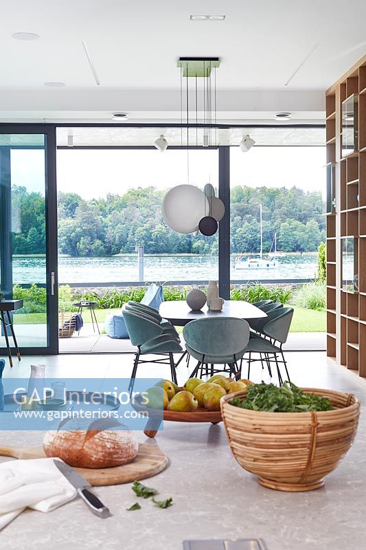 Contemporary kitchen diner with views to lake beyond 