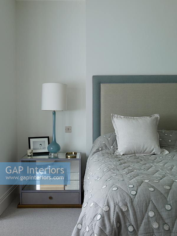 Modern bedroom with teal and grey accessories 