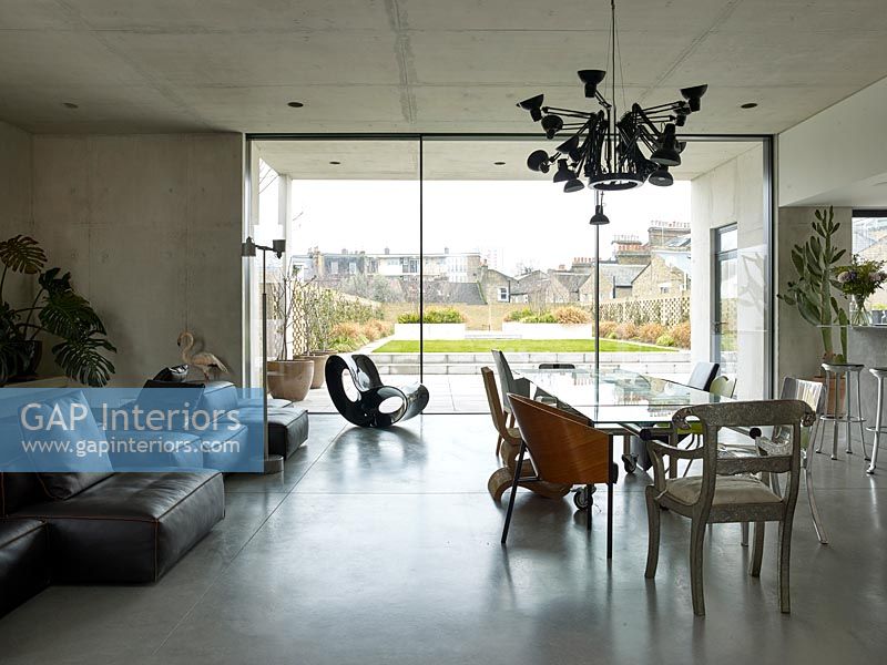 Contemporary concrete open plan living space with dining area