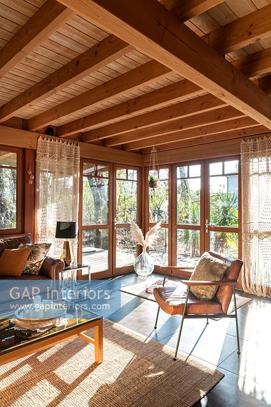 Country living room with sunshine pouring in through windows 