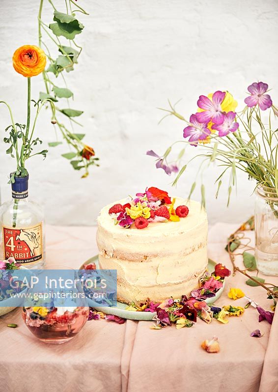Celebration cake covered in fruit and edible flowers 