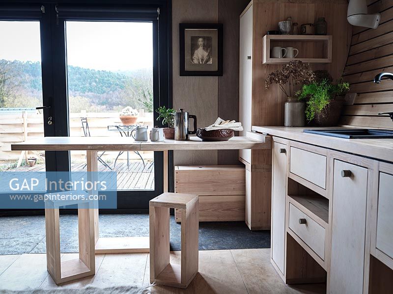 Fold out breakfast bar in small wooden kitchen 