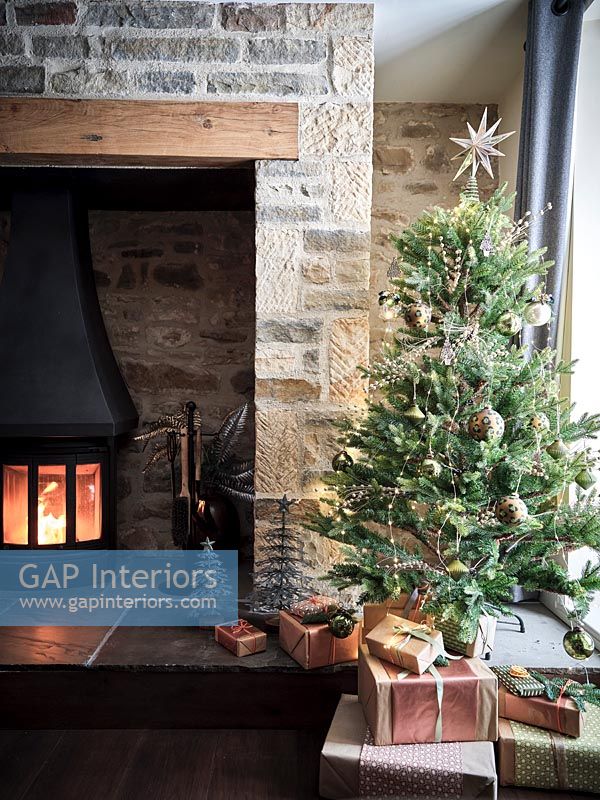 Christmas tree next to fireplace 