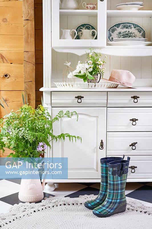 White wooden dresser with flowers and wellington boots - detail 