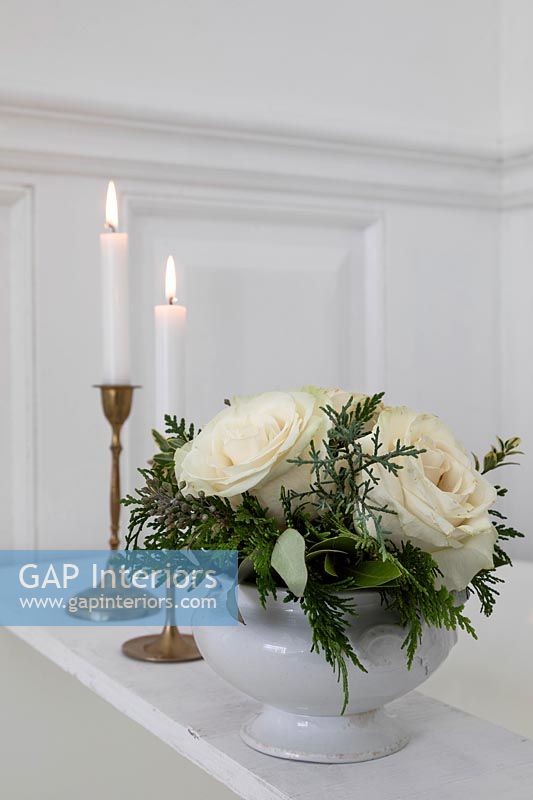 Flower arrangement and lit candles