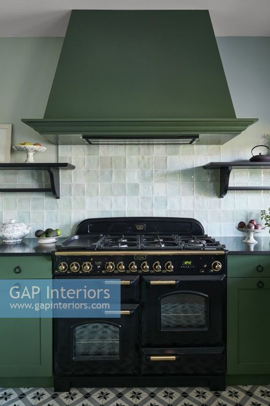 Large black range cooker and green extractor fan
