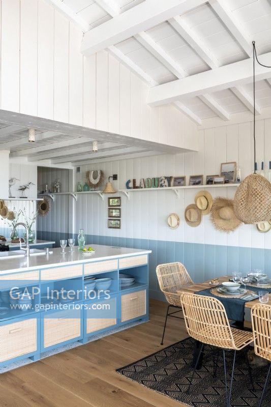 Blue and white kitchen-diner in coastal cabin