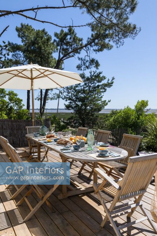 Outdoor dining area with coastal view in summer 