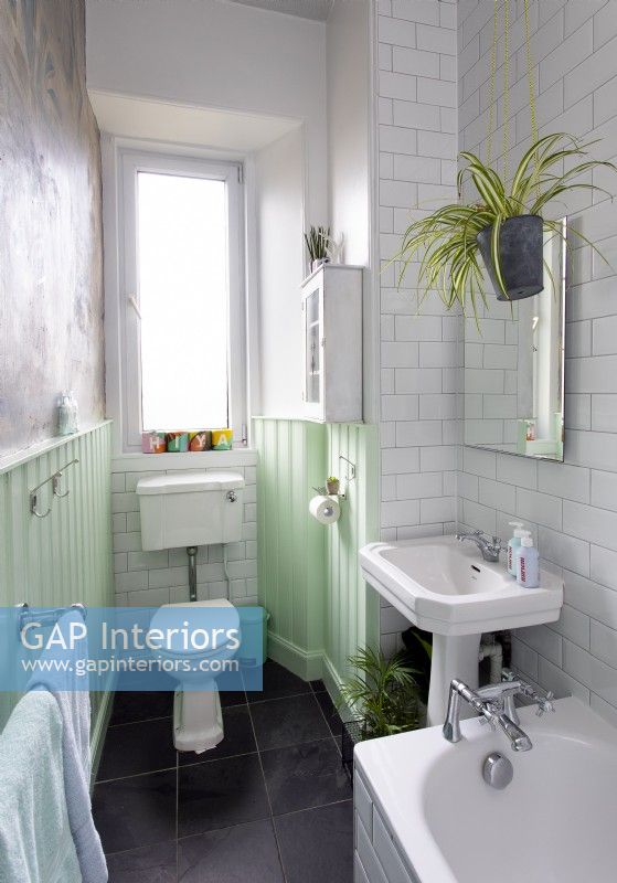 White bathroom with mint green painted woodwork