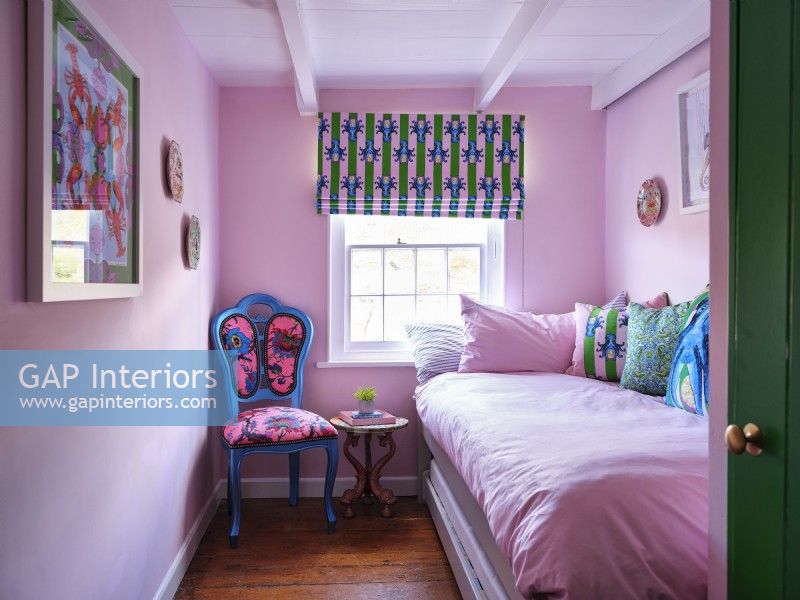 Pink bedroom with upholstered chair 