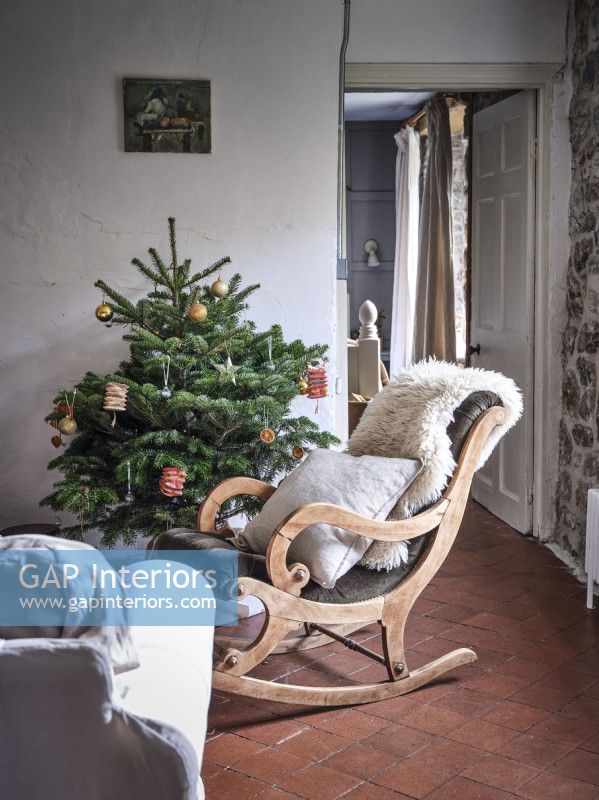 Country living room featuring seating and a Christmas tree 