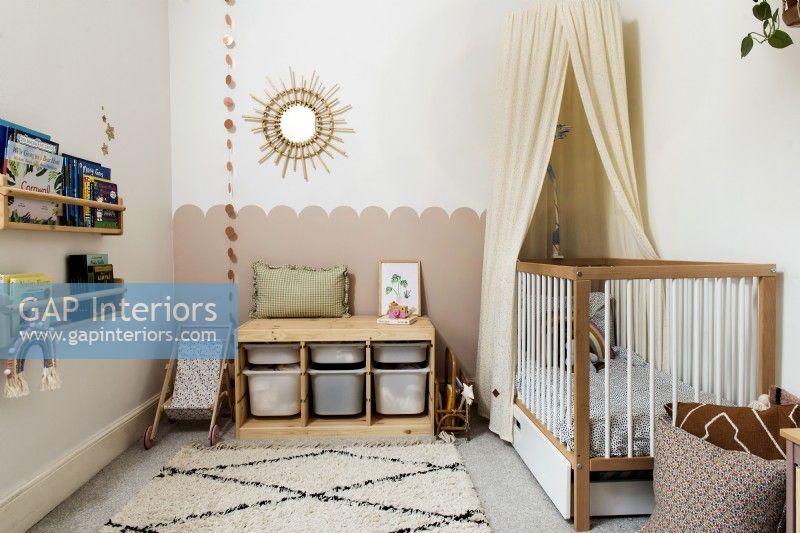 Nursery with cot and wooden storage bench seat