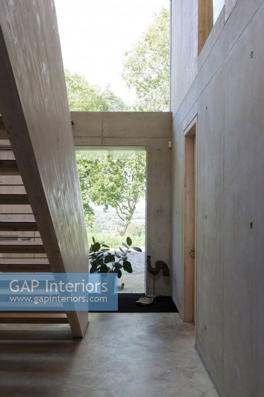 Contemporary stairs and entrance hall, ply and concrete.