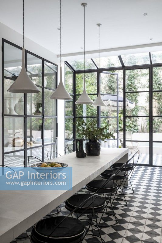 Contemporary black and white dining room with crittall doors 

