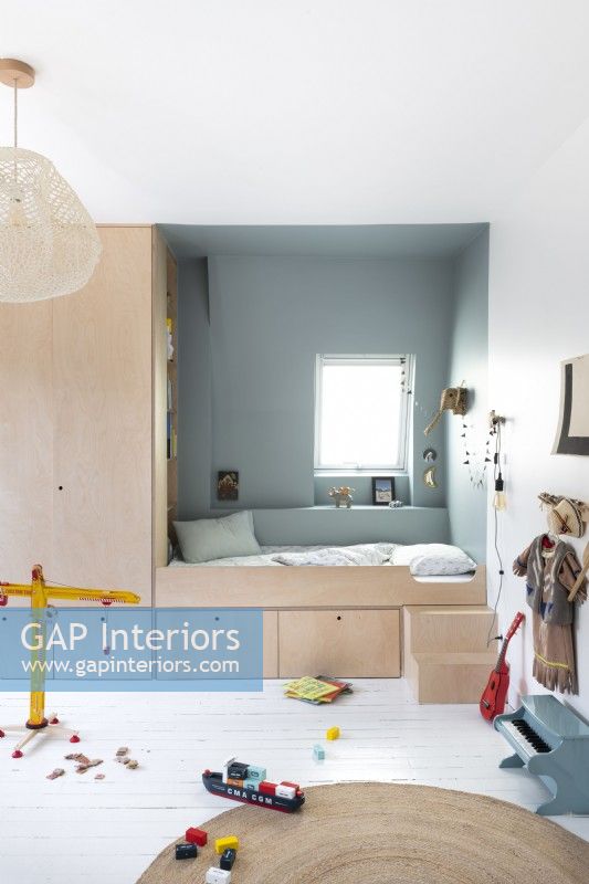 Childrens bedroom with built-in alcove bed and surrounding storage