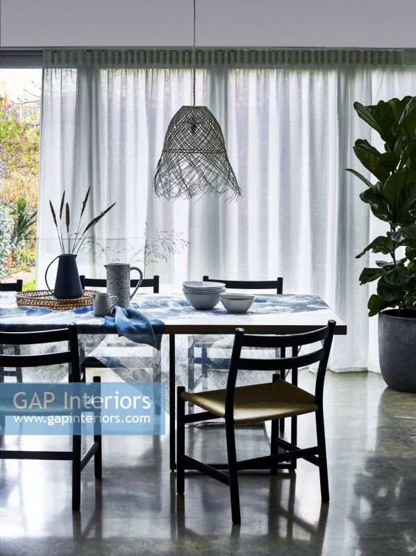 Dining room with voile diffuser curtains