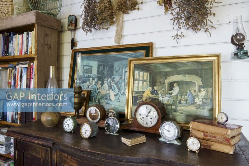 Collection of old clocks and painted pictures