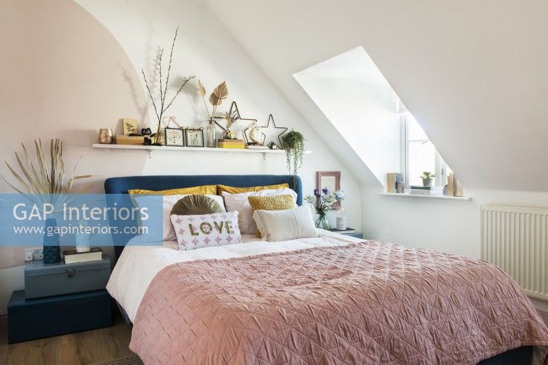 Attic bedroom with pink bedding