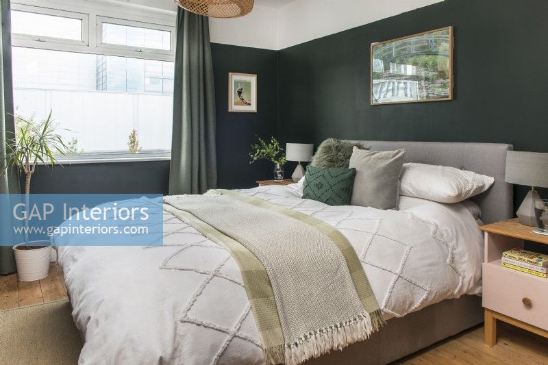 Modern bedroom with dark green painted walls