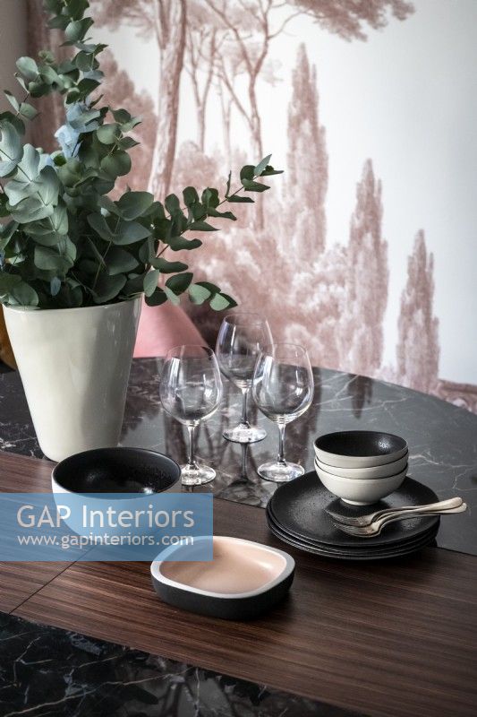 Crockery and glassware on modern dining table - detail