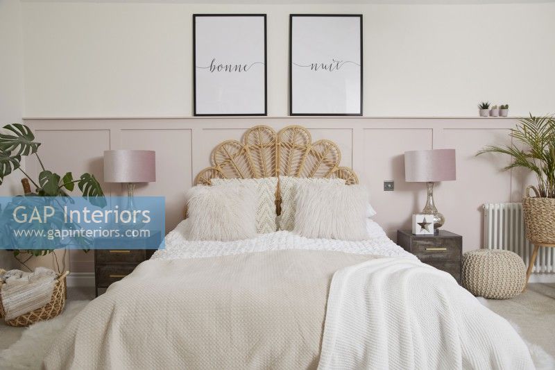 Master bedroom with pale pink panelling, a rattan headboard and soft furnishings.