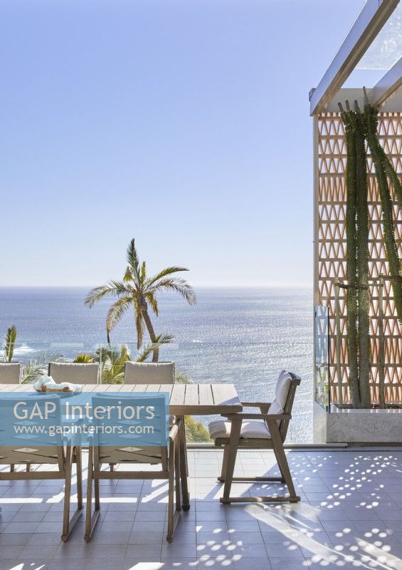 Outdoor dining area on terrace overlooking the ocean