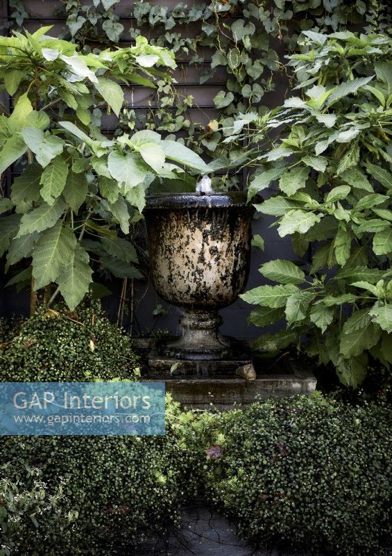 Urn water feature in garden - detail