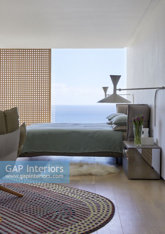 Contemporary bedroom with sea views