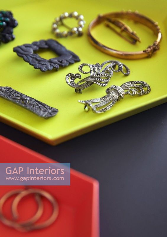 Detail of jewellery displayed on bright yellow tray