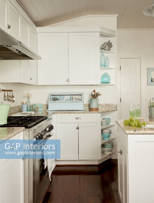 The completely redone kitchen gave Nikki a chance to come up with the just the right finishes to complement the rest of the house, like the white cabinetry, stainless appliances and blue accents. 