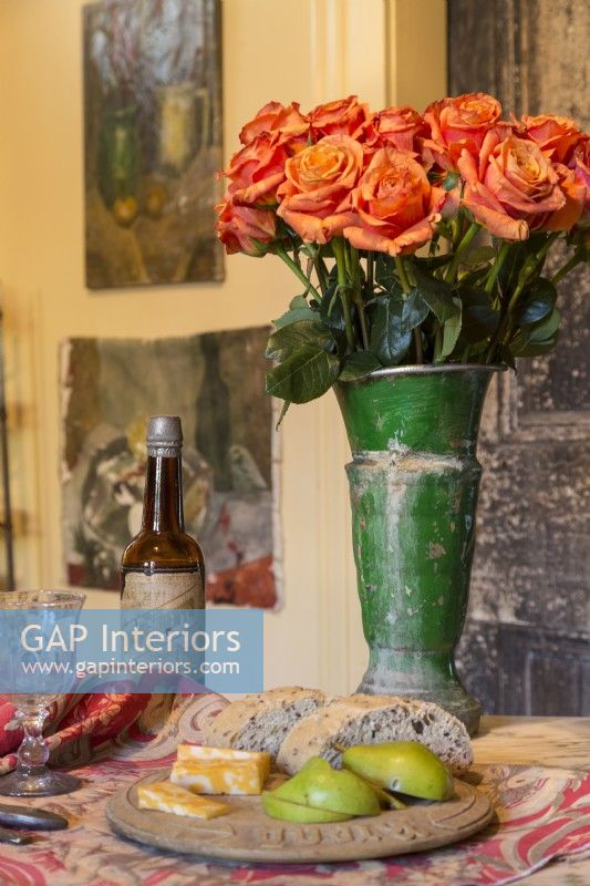 A galvanized tin flower vendorâ€™s vase is a memento of travels through Italy .